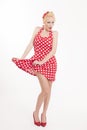 Young beautiful caucasian woman posing in a pin up red dress style Royalty Free Stock Photo