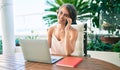 Young beautiful caucasian woman smiling happy working from home speaking on the phone Royalty Free Stock Photo