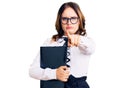 Young beautiful caucasian woman wearing business shirt and glasses holding folder pointing with finger to the camera and to you, Royalty Free Stock Photo