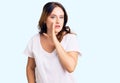 Young beautiful caucasian woman wearing casual white tshirt hand on mouth telling secret rumor, whispering malicious talk Royalty Free Stock Photo