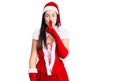 Young beautiful caucasian woman wearing santa claus costume asking to be quiet with finger on lips Royalty Free Stock Photo