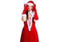 Young beautiful caucasian woman wearing santa claus costume trying to open eyes with fingers, sleepy and tired for morning fatigue Royalty Free Stock Photo