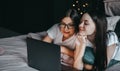 Young beautiful caucasian women`s lesbian couple lover, using laptop computer Royalty Free Stock Photo