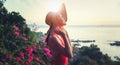 Young beautiful cheerful woman in bikini and hat enjoying tropical vacation with sea view at sunset Royalty Free Stock Photo