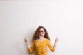 A young beautiful cheerful woman with red sunglasses in studio. Copy space. Royalty Free Stock Photo