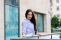 Young beautiful cheerful woman walking on old street at tropical town. Pretty girl looking at you and smiling Royalty Free Stock Photo