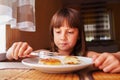 Young beautiful child girl eating cheesecakes for breakfast Royalty Free Stock Photo