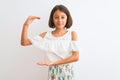 Young beautiful child girl wearing casual dress standing over isolated white background gesturing with hands showing big and large Royalty Free Stock Photo