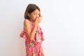 Young beautiful child girl wearing pink floral dress standing over isolated white background smelling something stinky and Royalty Free Stock Photo