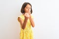 Young beautiful child girl wearing yellow floral dress standing over isolated white background Ready to fight with fist defense