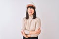 Young beautiful Chinese architect woman wearing helmet over isolated white background happy face smiling with crossed arms looking Royalty Free Stock Photo