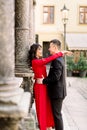 Young beautiful Chinese couple in love hugging each other on old city street, summer Europe vacation, travel, fun, happy Royalty Free Stock Photo