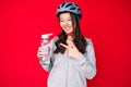 Young beautiful chinese girl wearing bike helmet and holding water bottle smiling happy pointing with hand and finger Royalty Free Stock Photo