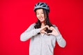 Young beautiful chinese girl wearing bike helmet smiling in love showing heart symbol and shape with hands Royalty Free Stock Photo