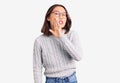 Young beautiful chinese girl wearing casual clothes hand on mouth telling secret rumor, whispering malicious talk conversation Royalty Free Stock Photo