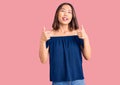 Young beautiful chinese girl wearing casual clothes success sign doing positive gesture with hand, thumbs up smiling and happy Royalty Free Stock Photo