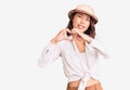 Young beautiful chinese girl wearing explorer hat smiling in love showing heart symbol and shape with hands Royalty Free Stock Photo