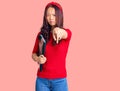 Young beautiful chinese girl wearing student folder pointing with finger to the camera and to you, confident gesture looking Royalty Free Stock Photo