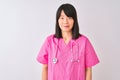 Young beautiful Chinese nurse woman wearing stethoscope over isolated white background Relaxed with serious expression on face Royalty Free Stock Photo