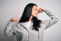 Young beautiful chinese sporty woman wearing sweatshirt over isolated white background showing arms muscles smiling proud Royalty Free Stock Photo