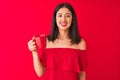 Young beautiful chinese woman drinking cup of coffee standing over isolated red background with a happy face standing and smiling Royalty Free Stock Photo