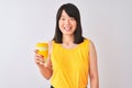 Young beautiful Chinese woman drinking take away coffee over isolated white background with a happy face standing and smiling with Royalty Free Stock Photo
