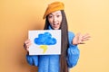 Young beautiful chinese woman holdig cloud and thunder draw celebrating achievement with happy smile and winner expression with