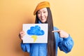Young beautiful chinese woman holdig cloud and thunder draw smiling happy pointing with hand and finger