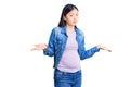 Young beautiful chinese woman pregnant expecting baby clueless and confused with open arms, no idea concept Royalty Free Stock Photo