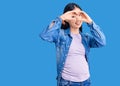 Young beautiful chinese woman pregnant expecting baby doing heart shape with hand and fingers smiling looking through sign Royalty Free Stock Photo