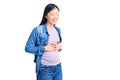 Young beautiful chinese woman pregnant expecting baby smiling and laughing hard out loud because funny crazy joke with hands on Royalty Free Stock Photo