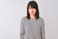 Young beautiful chinese woman wearing black striped t-shirt over isolated white background depressed and worry for distress, Royalty Free Stock Photo