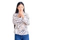 Young beautiful chinese woman wearing casual shirt suffering pain on hands and fingers, arthritis inflammation