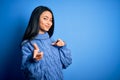 Young beautiful chinese woman wearing casual sweater over isolated blue background pointing fingers to camera with happy and funny Royalty Free Stock Photo