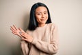 Young beautiful chinese woman wearing casual sweater over isolated white background clapping and applauding happy and joyful, Royalty Free Stock Photo