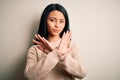 Young beautiful chinese woman wearing casual sweater over isolated white background Rejection expression crossing arms doing Royalty Free Stock Photo