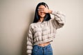 Young beautiful chinese woman wearing casual sweater over isolated white background smiling and laughing with hand on face Royalty Free Stock Photo