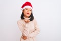 Young beautiful chinese woman wearing Christmas Santa hat over isolated white background looking at the camera blowing a kiss with Royalty Free Stock Photo