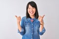 Young beautiful chinese woman wearing denim shirt over isolated white background success sign doing positive gesture with hand, Royalty Free Stock Photo