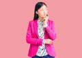 Young beautiful chinese woman wearing elegant clothes serious face thinking about question with hand on chin, thoughtful about