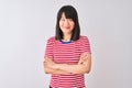 Young beautiful chinese woman wearing red striped t-shirt over isolated white background happy face smiling with crossed arms Royalty Free Stock Photo