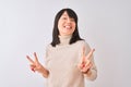 Young beautiful chinese woman wearing turtleneck sweater over isolated white background smiling looking to the camera showing Royalty Free Stock Photo