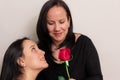 Beautiful Colombian teenage girl gives her mother a rose on Mother`s Day