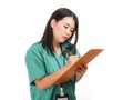 Young beautiful and confident Asian Chinese medicine doctor or hospital nurse woman holding medical reports clipboard wearing Royalty Free Stock Photo