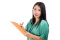 Young beautiful and confident Asian Chinese medicine doctor or hospital nurse woman holding medical reports clipboard wearing Royalty Free Stock Photo