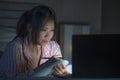 Young beautiful and confident Asian Chinese student girl researching and studying at home preparing exam with laptop computer on Royalty Free Stock Photo