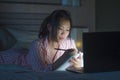 Young beautiful and confident Asian Chinese student girl researching and studying at home preparing exam with laptop computer on Royalty Free Stock Photo