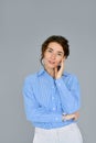 Young beautiful confident business woman at grey background, vertical portrait. Royalty Free Stock Photo