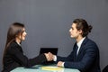 Young beautiful couple of business workers smiling happy and confident shaking hands with smile on face for agreement at office on Royalty Free Stock Photo
