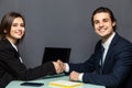 Young beautiful couple of business workers smiling happy and confident shaking hands with smile on face for agreement at office on Royalty Free Stock Photo